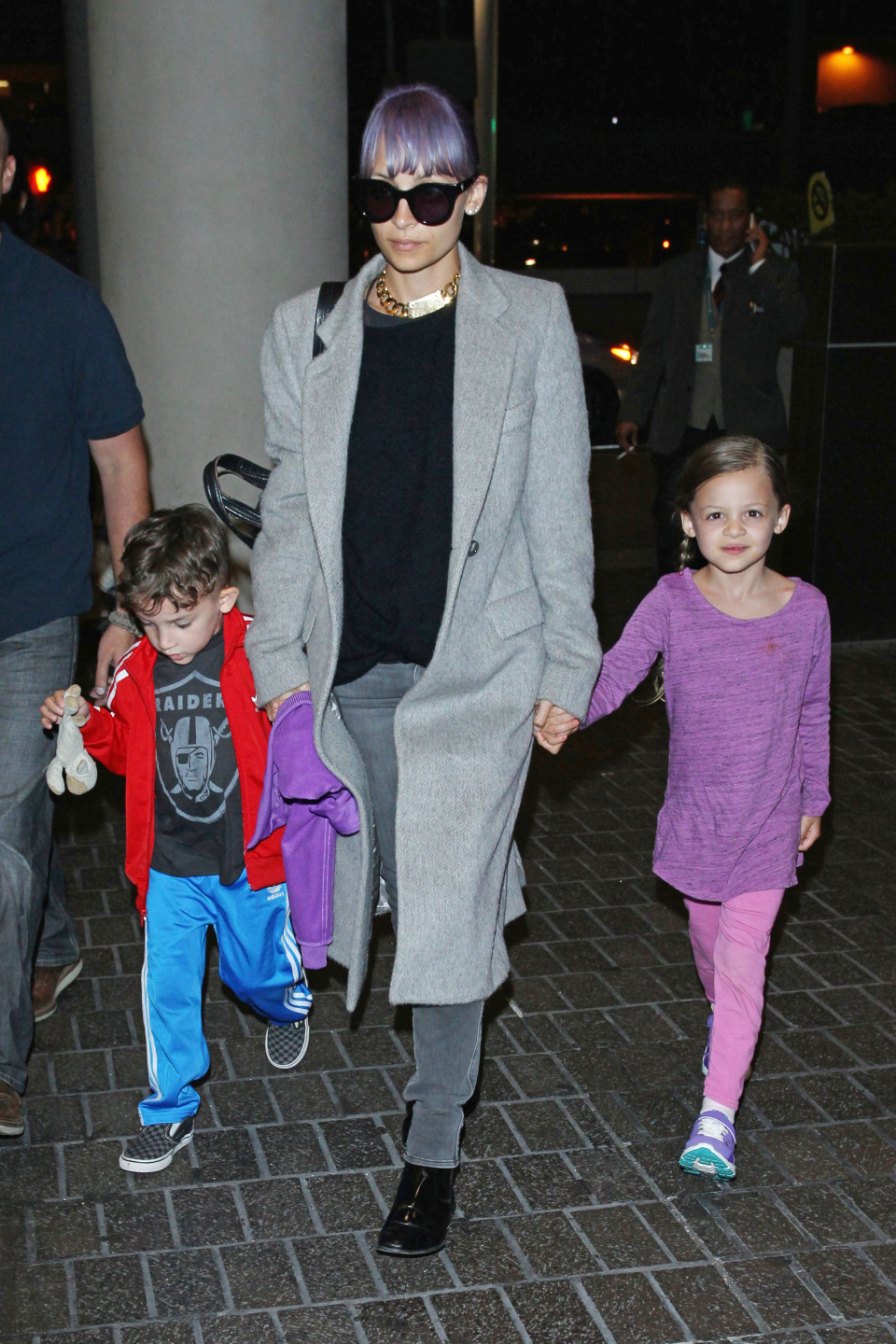 **USA ONLY** Los Angeles, CA - Nicole Richie, her daughter Harlow and son Sparrow hold hands as they make their way through the terminal at LAX. The purple haired reality star dressed low-key in a grey overcoat, black sweater, jeans and black ankle boots. Nicole accessorized with a pair of wayfarer sunglasses and an impressive gold chain. AKM-GSI June 22, 2014 **USA ONLY** To License These Photos, Please Contact : Steve Ginsburg (310) 505-8447 (323) 423-9397 steve@akmgsi.com sales@akmgsi.com or Maria Buda (917) 242-1505 mbuda@akmgsi.com ginsburgspalyinc@gmail.com