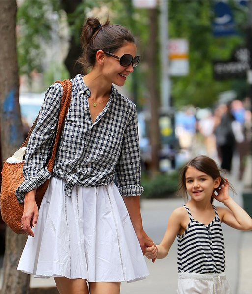 Suri Cruise shows a wide range of expressions as she walks with Katie Holmes in NYC