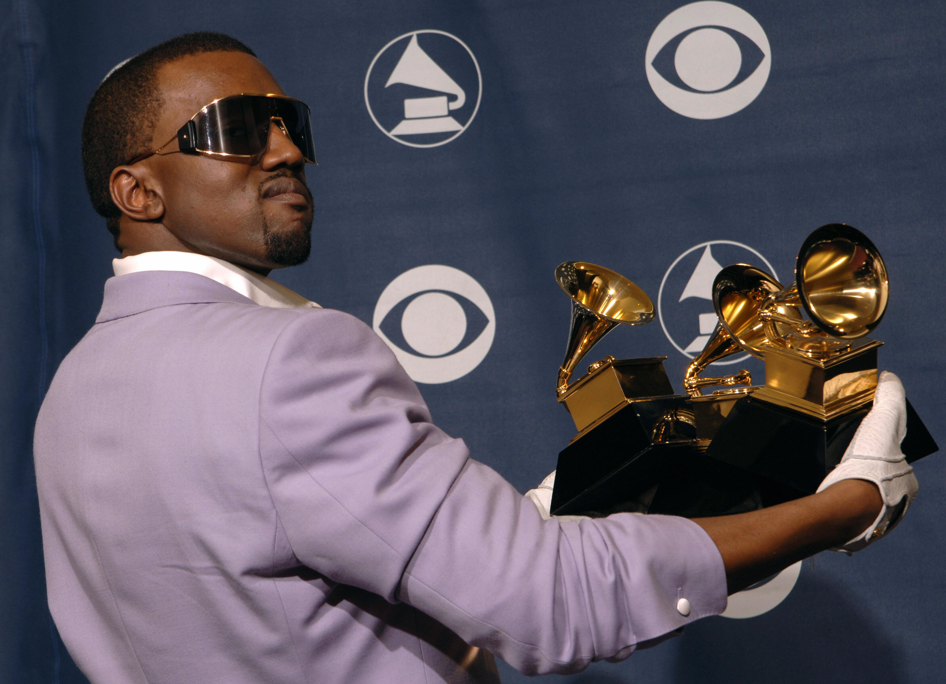 Los Angeles, UNITED STATES: US rapper Kanye West poses with the three awards he won at the Grammy Awards in Los Angeles 08 February 2006. West won for best rap solo performance, best rap song and best rap album. AFP PHOTO/Susan GOLDMAN (Photo credit should read SUSAN GOLDMAN/AFP/Getty Images)